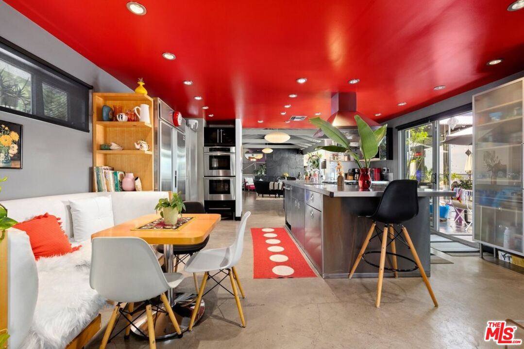 a living room with furniture and kitchen view