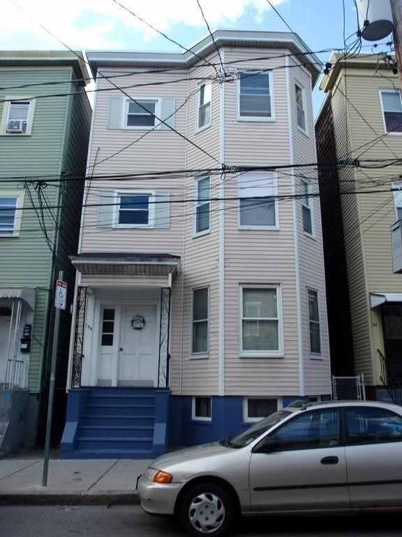 a front view of a house with parking space