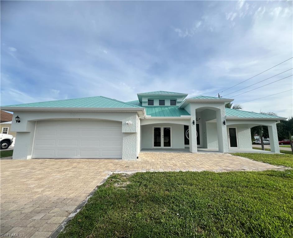 View of front of house featuring a front yard and a garage