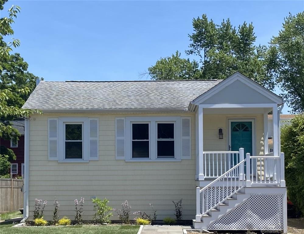 a view of a brick house with a small yard