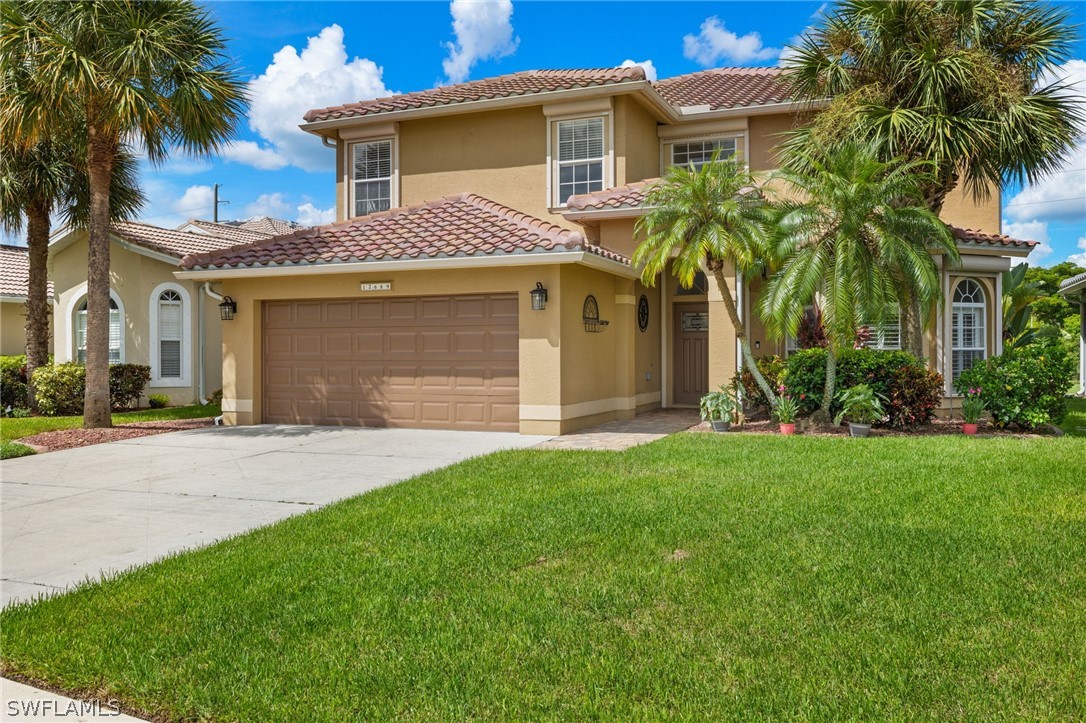 a front view of a house with a garden and palm trees