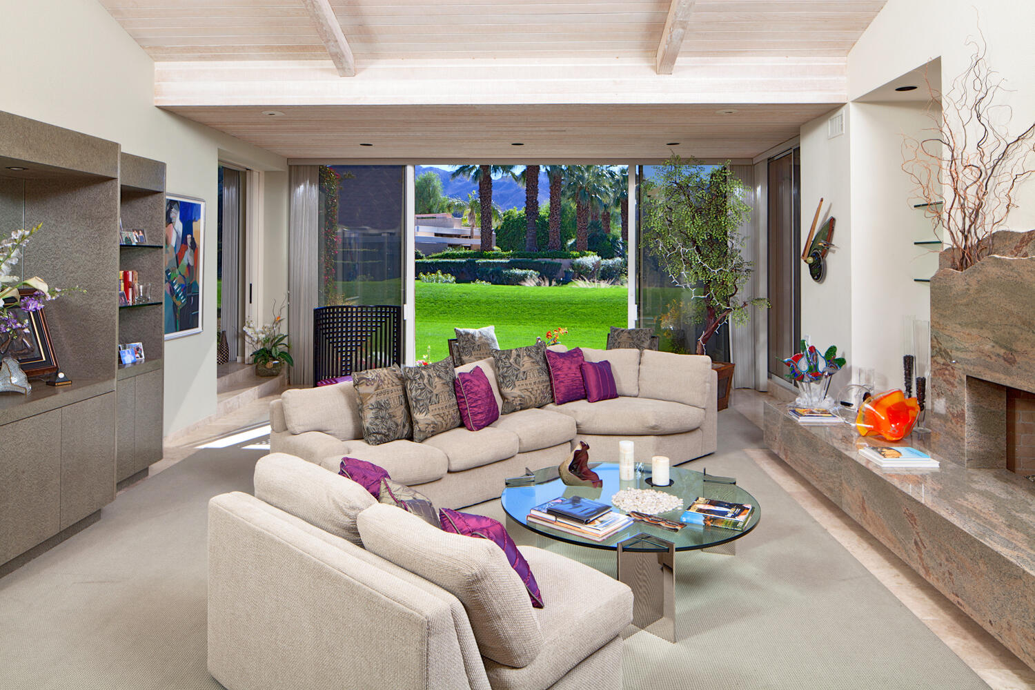 a living room with patio furniture and a floor to ceiling window