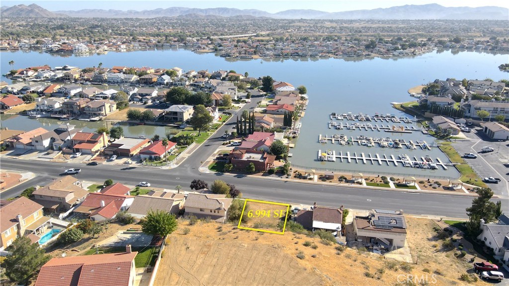 an aerial view of lake and residential houses with outdoor space