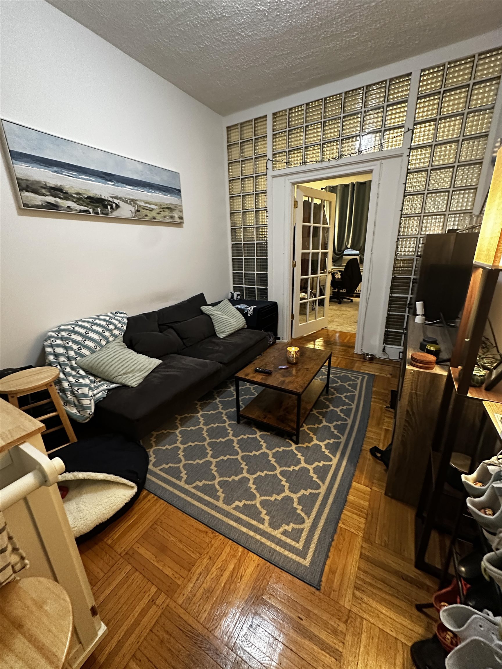 a living room with furniture and a floor to ceiling window