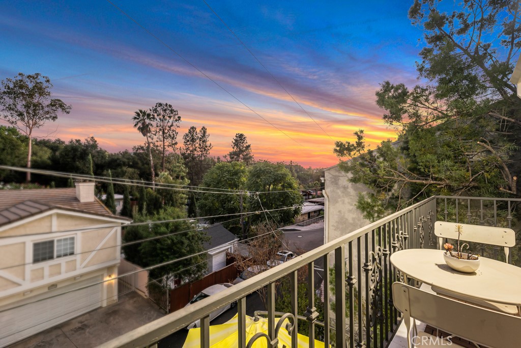 a view of a balcony with two chairs and a table