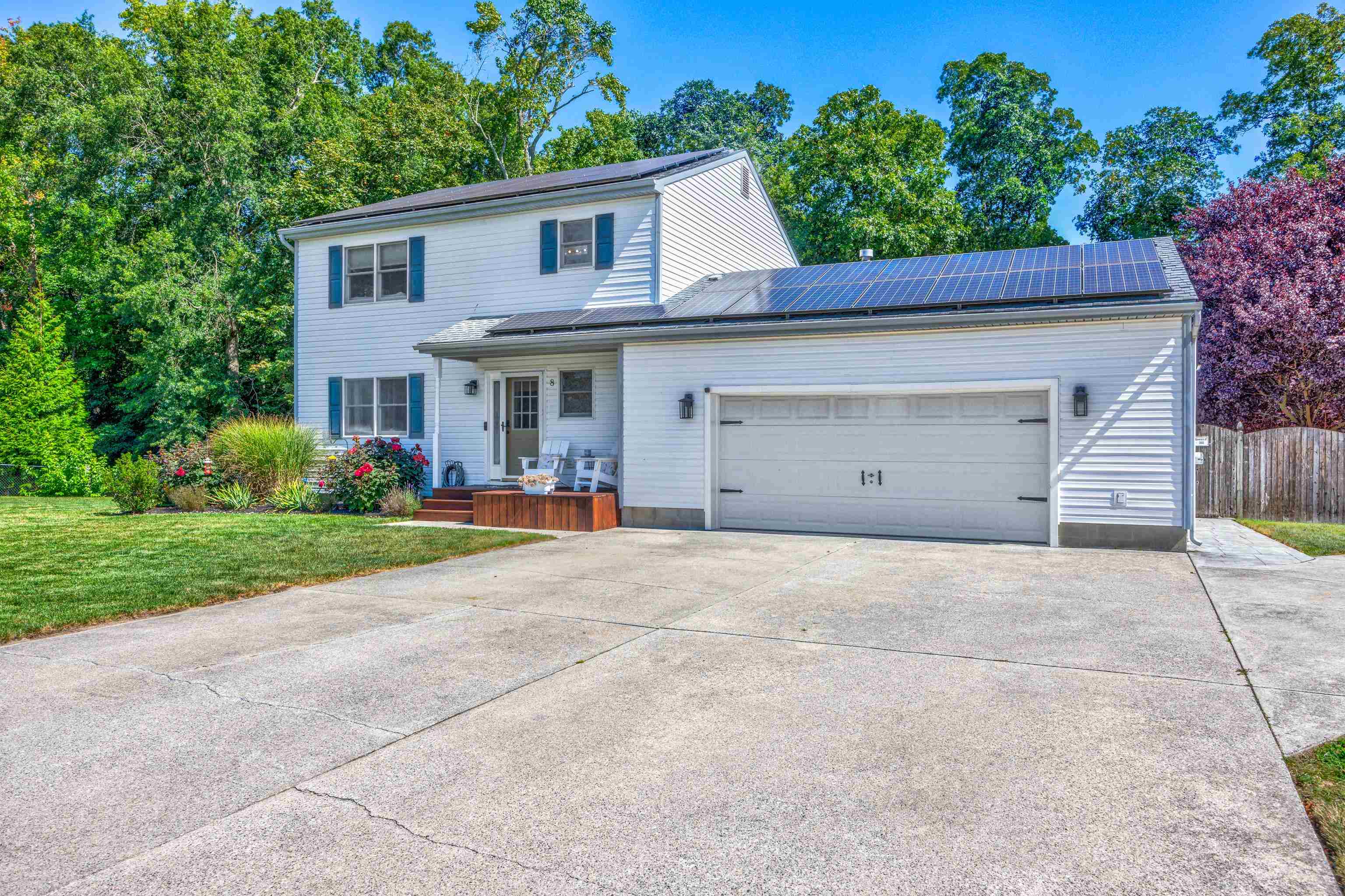 a front view of house with yard and trees around