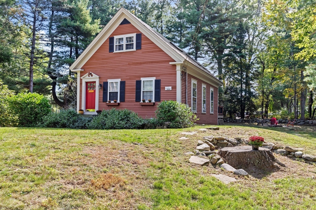 a view of a house with backyard and sitting area