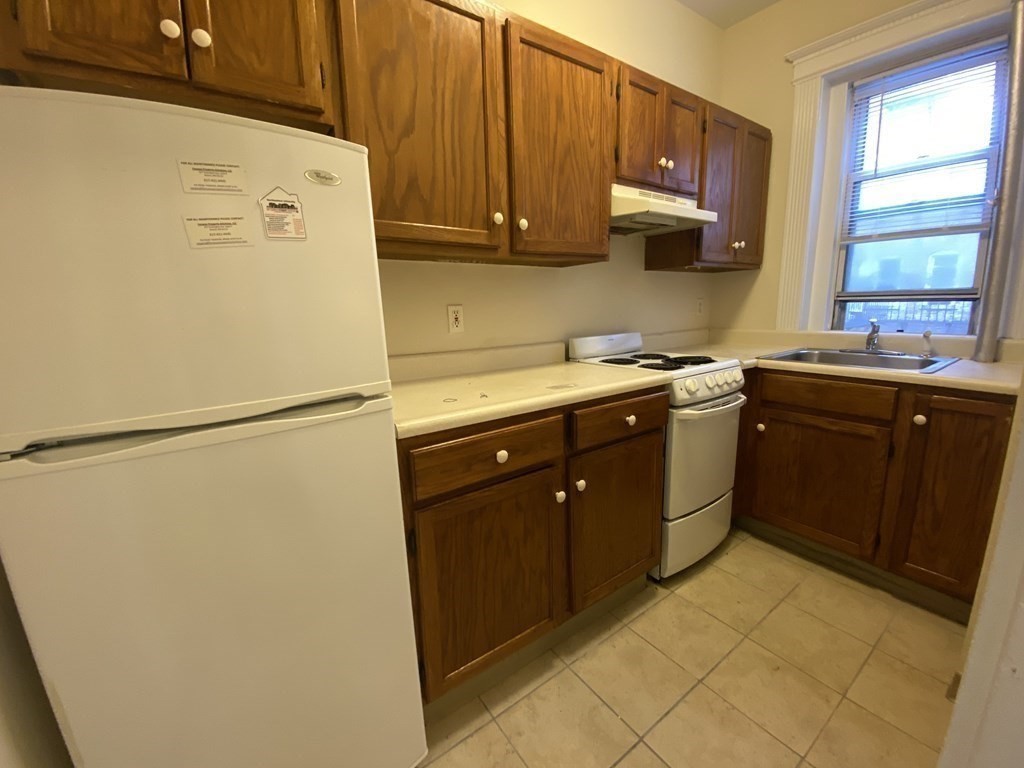 a kitchen with stainless steel appliances a refrigerator sink and cabinets