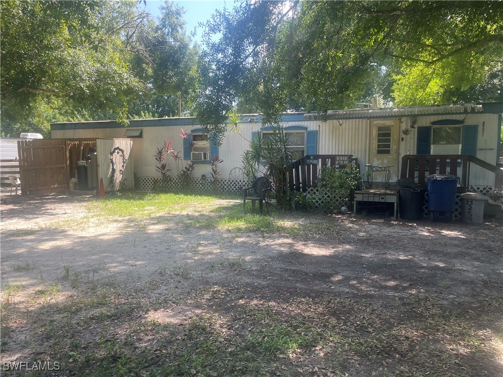 a view of a house with backyard stove and sitting area