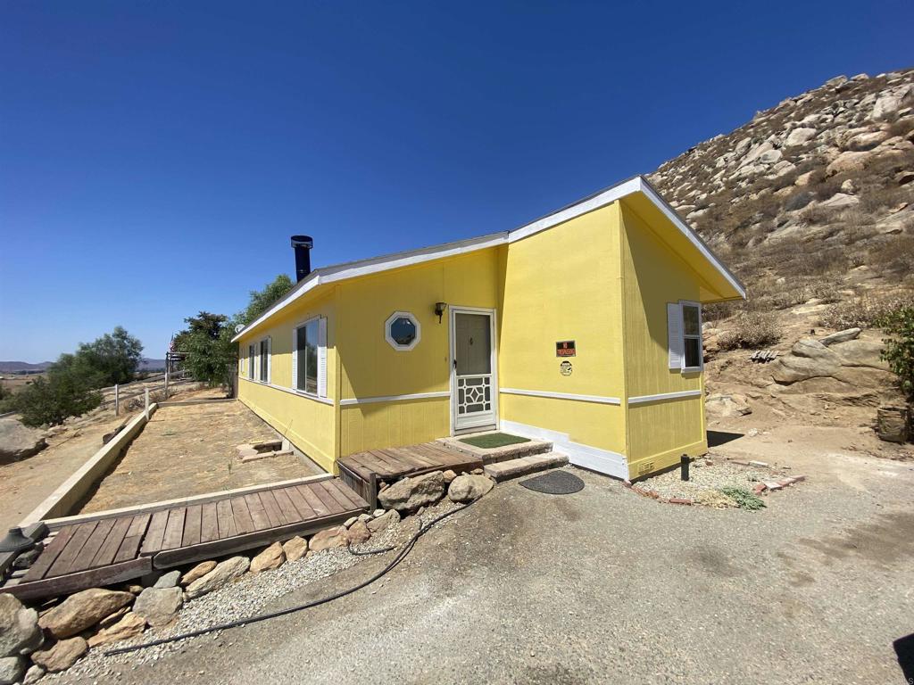 a view of a house with a floor and wooden fence