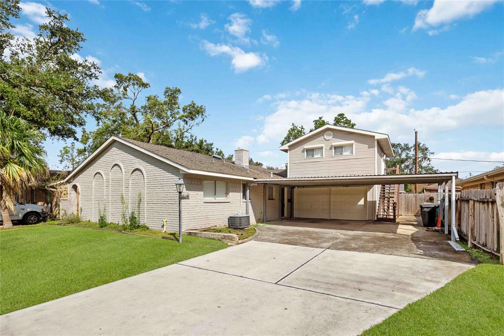 a front view of a house with a garden and yard