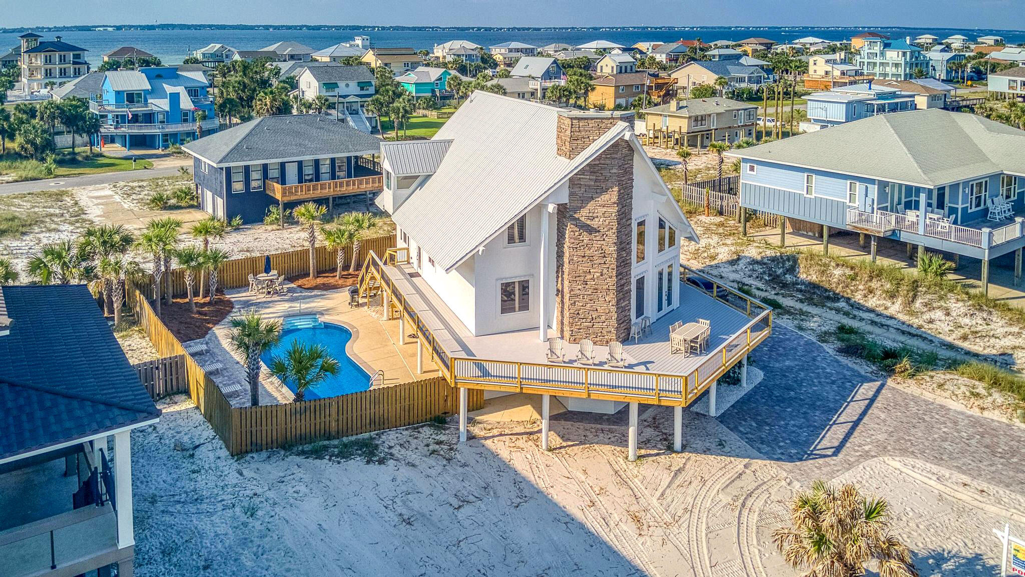 an aerial view of a house with swimming pool and outdoor seating