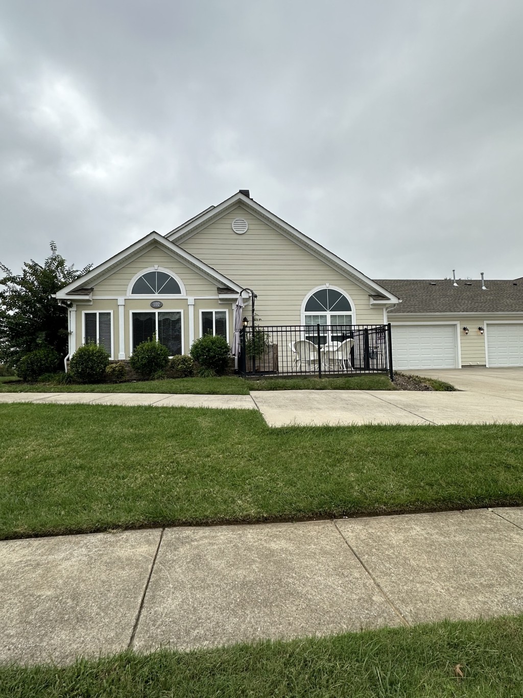 a front view of a house with a garden