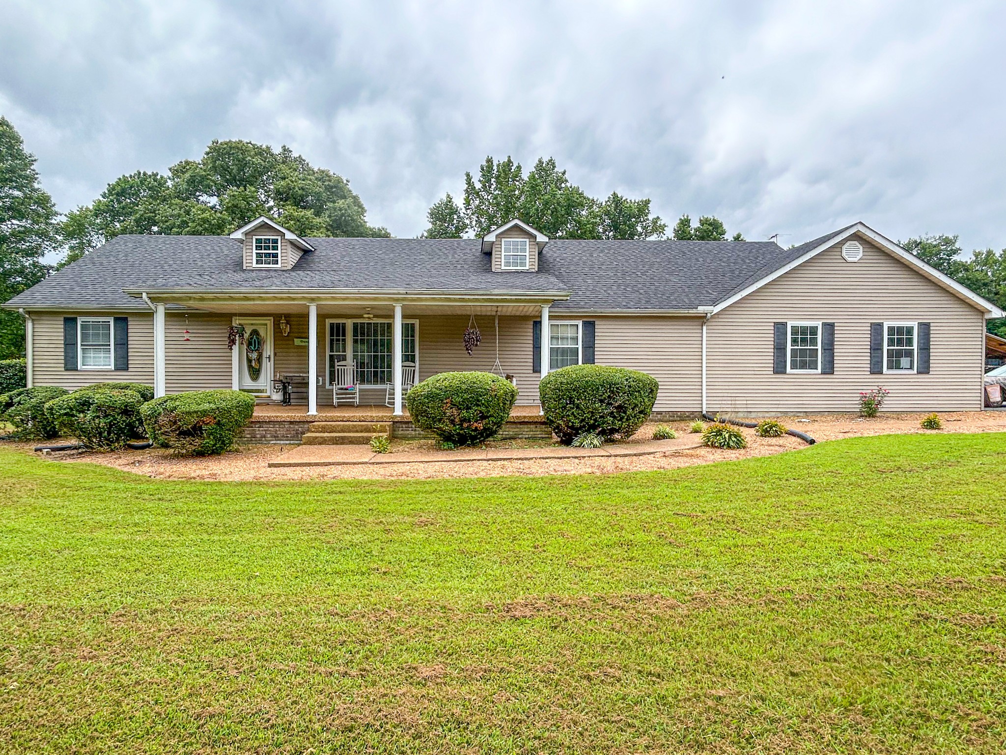 a front view of house with yard and outdoor seating