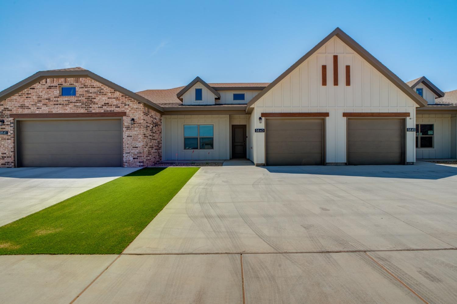 a front view of a house with a garden and yard