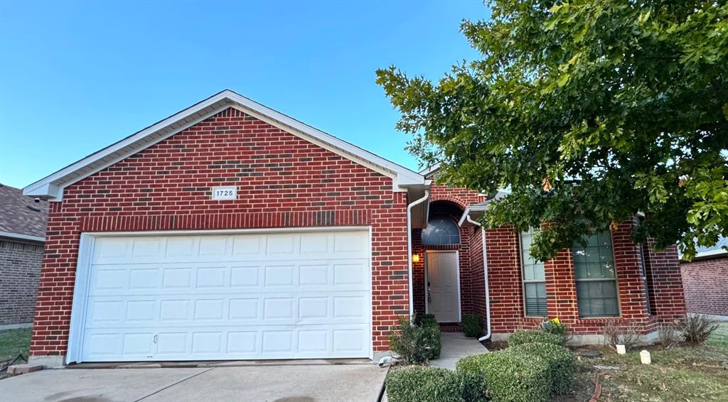 a front view of a house with garage