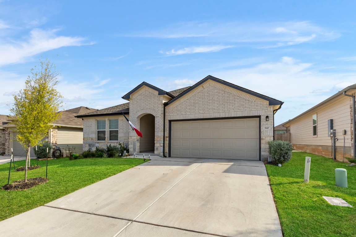 a front view of house with yard and green space