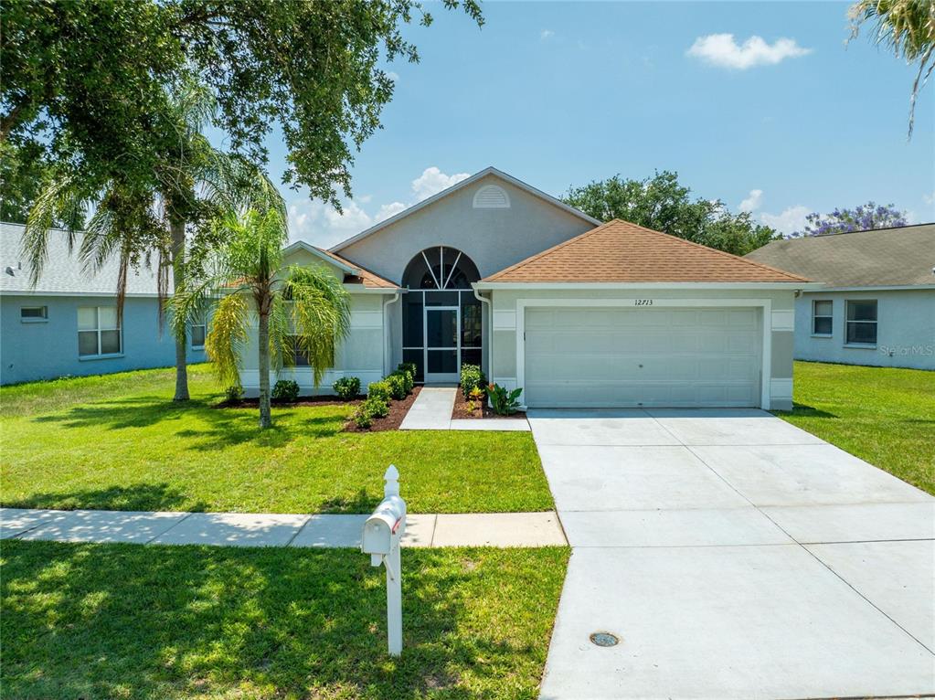 a front view of a house with a yard and garage