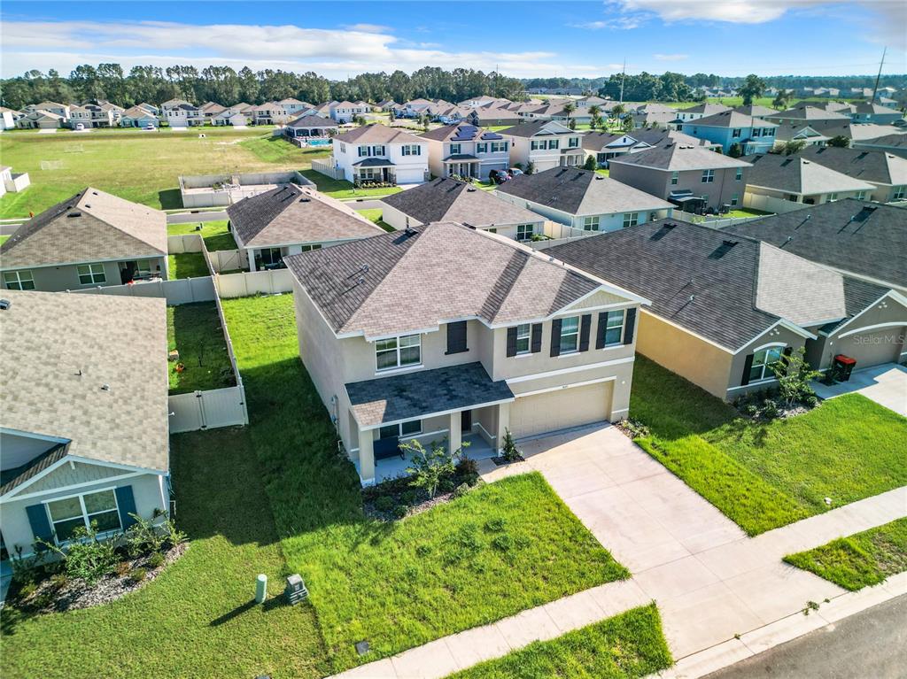 an aerial view of house with yard swimming pool and outdoor seating