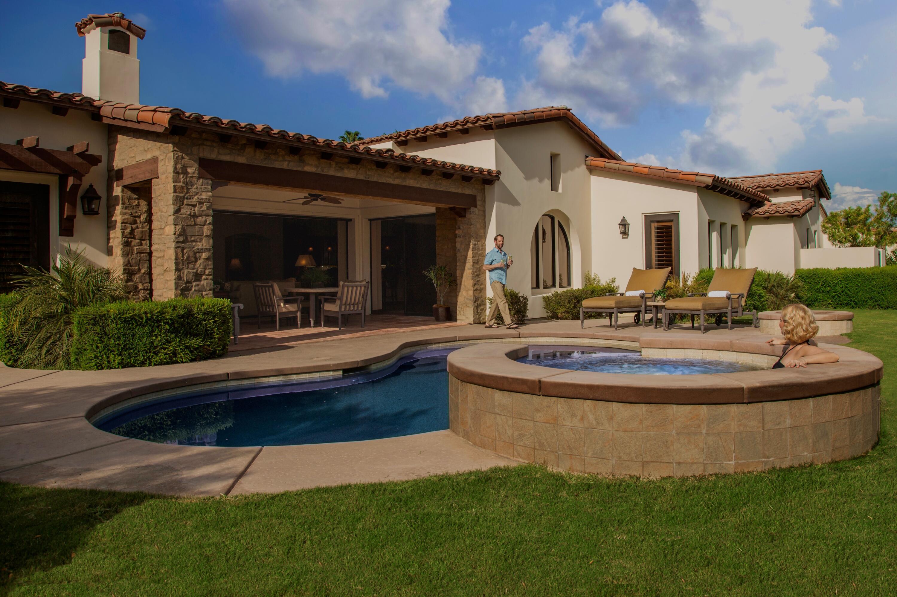 a view of a house with swimming pool and a yard