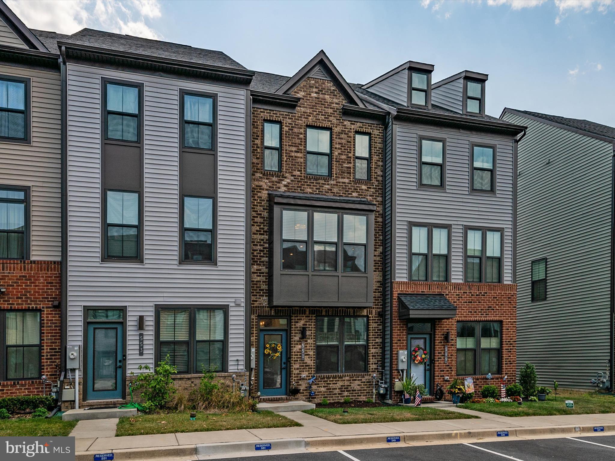 a front view of a residential apartment building with a yard