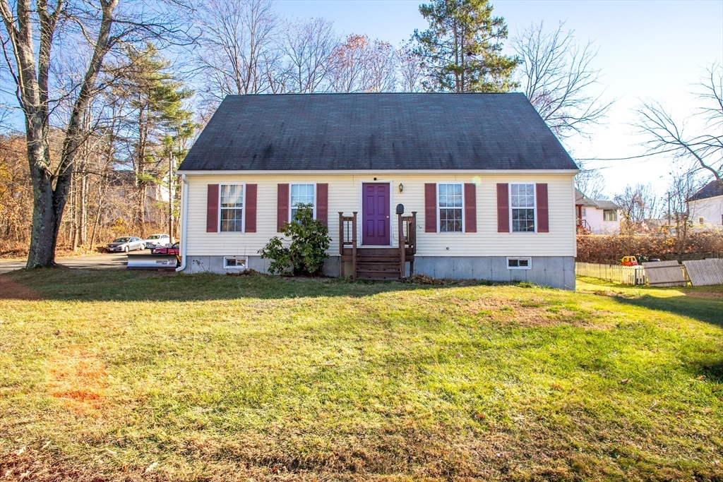 a view of house with yard and outdoor seating