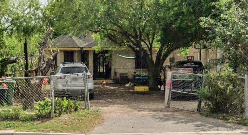 a front view of a house with a tree