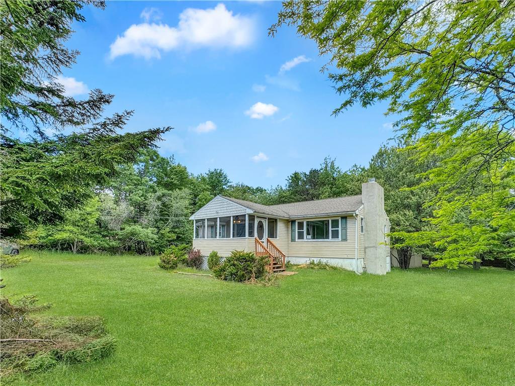 a view of house with backyard space and garden