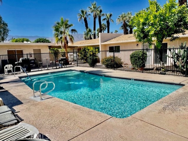 a view of a house with swimming pool and sitting area