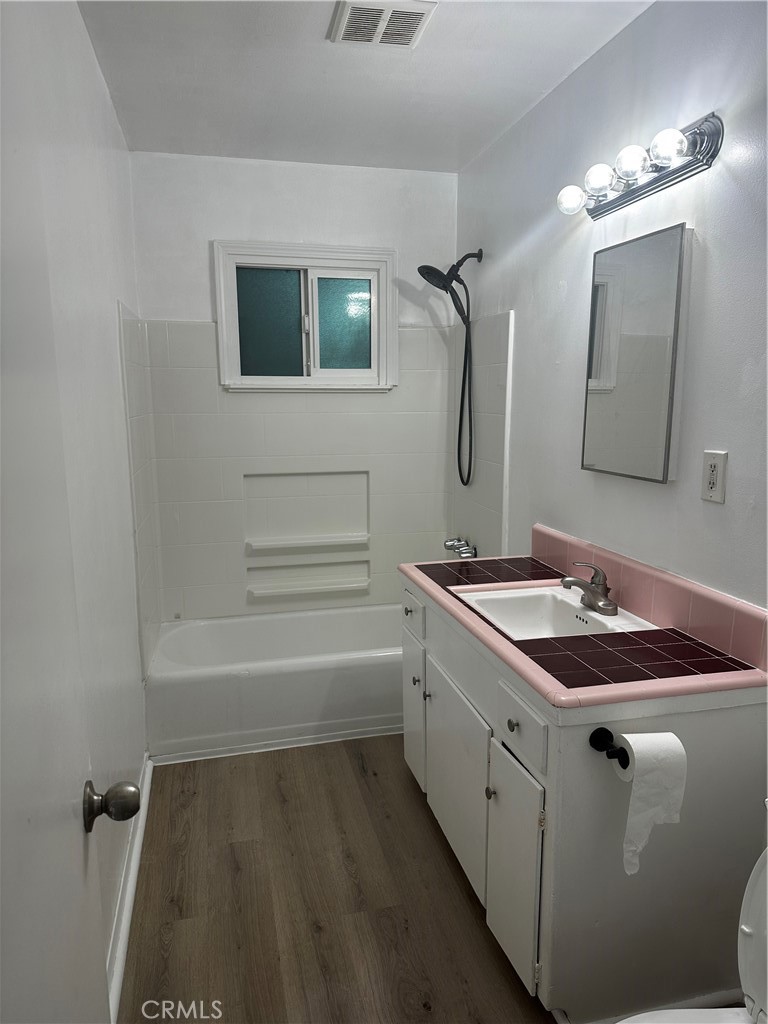 a bathroom with a granite countertop sink a toilet and mirror