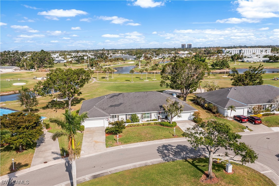 an aerial view of residential houses with outdoor space and ocean view