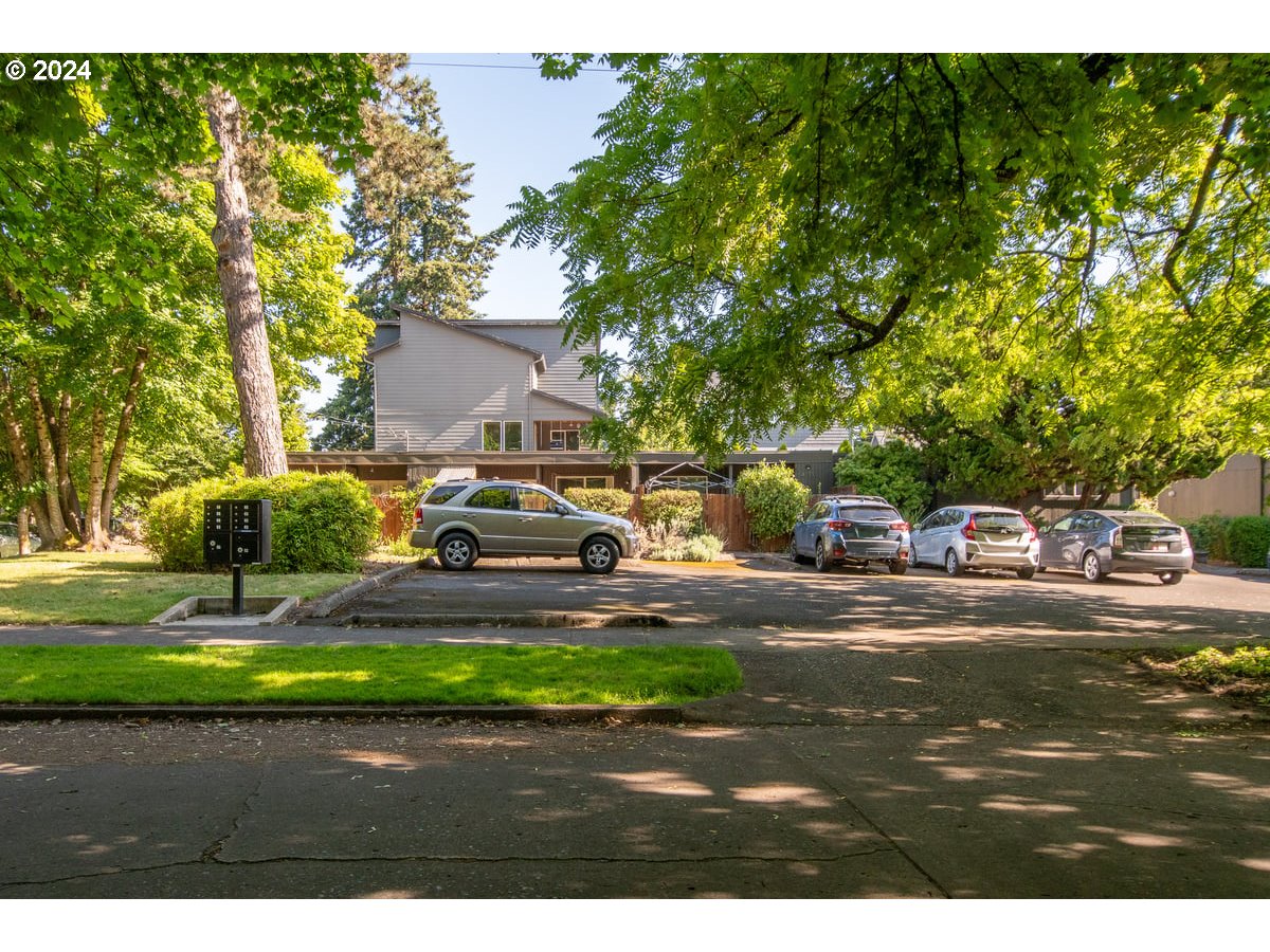 a view of a yard with cars parked