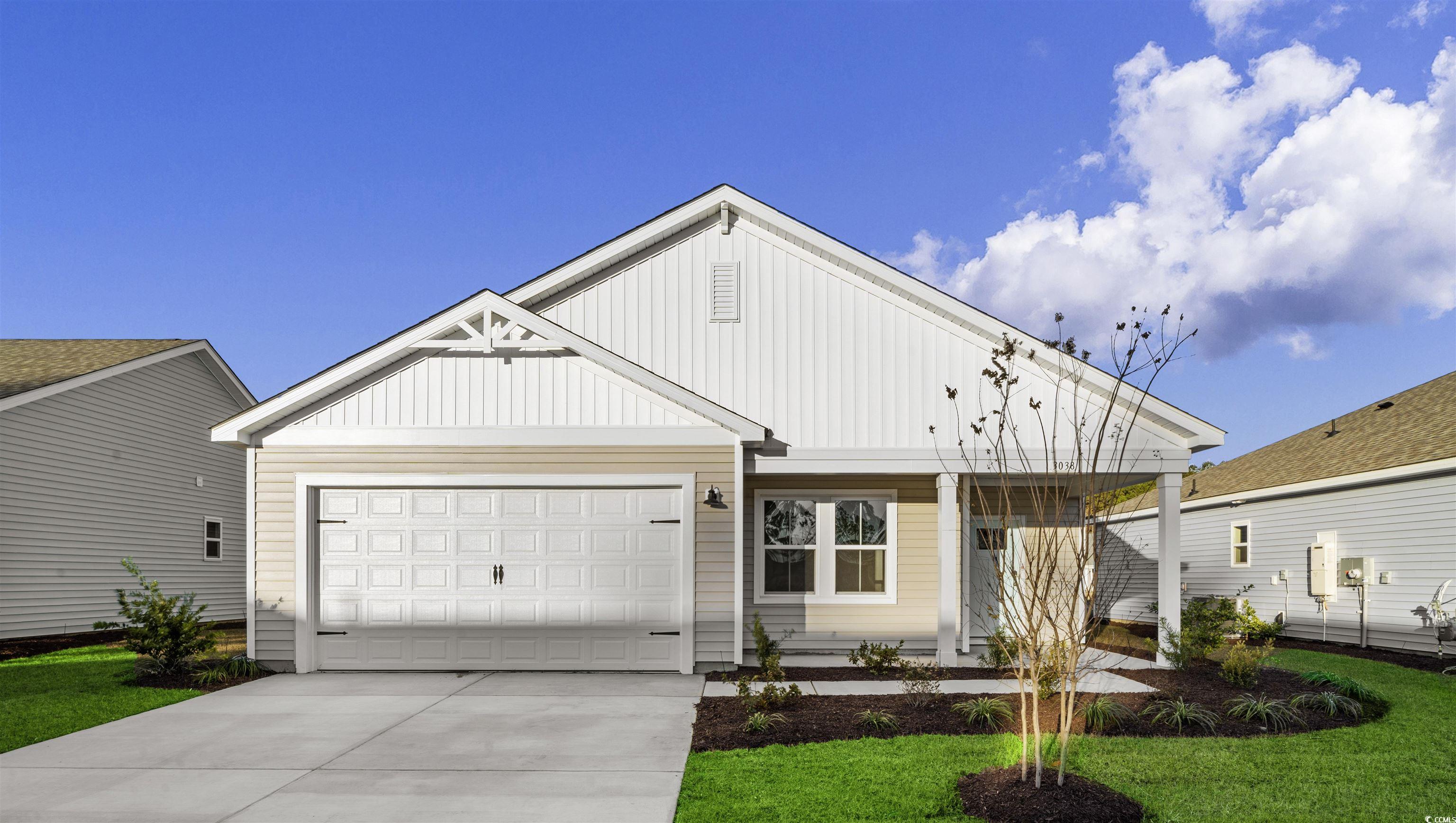 View of front facade with a garage and a front law