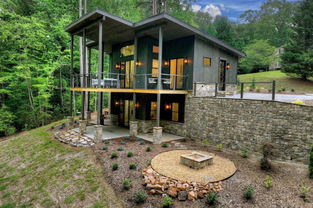 a backyard of a house with barbeque oven table and chairs