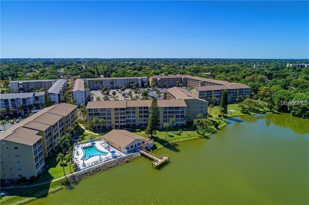 an aerial view of a house with a garden and lake view