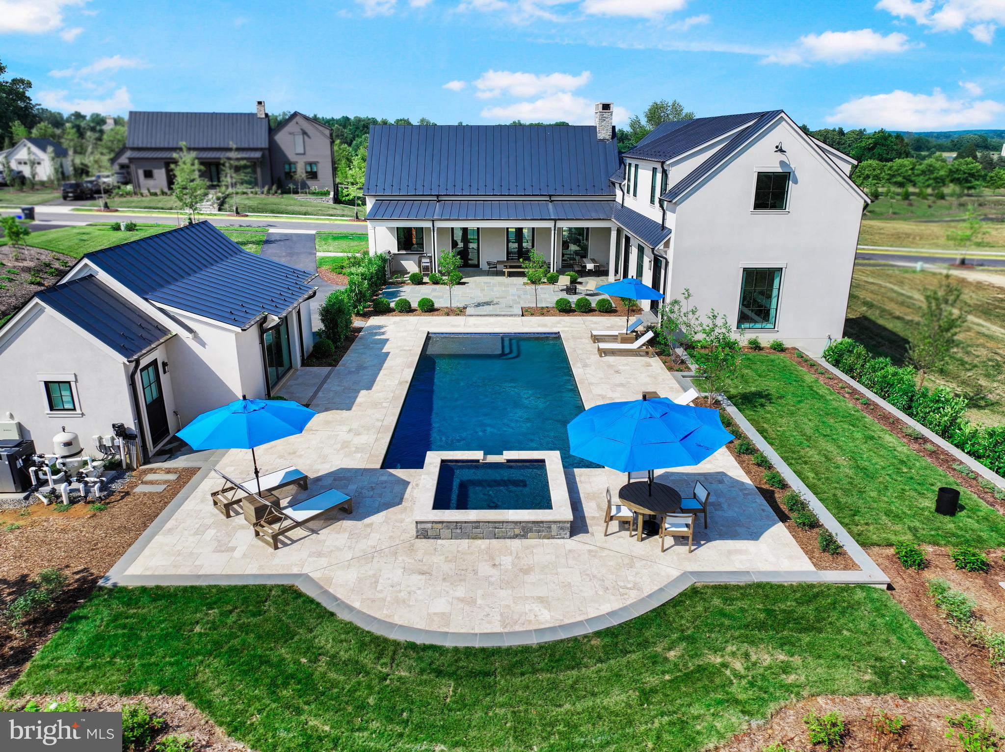 a aerial view of a house with swimming pool and a yard