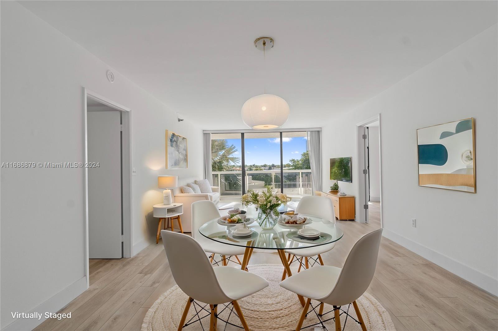 a view of a dining room with furniture a chandelier and wooden floor