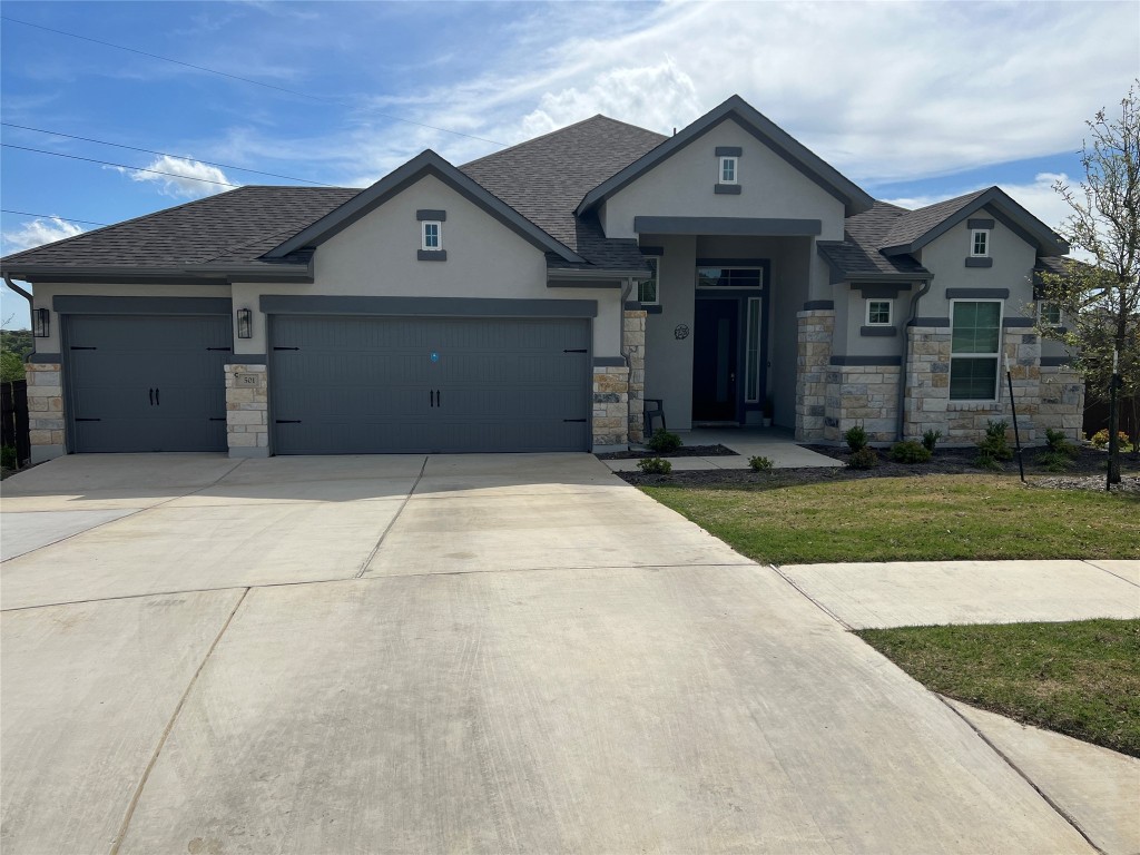 a front view of a house with a yard and garage