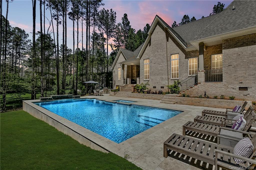 a view of a house with swimming pool and sitting area