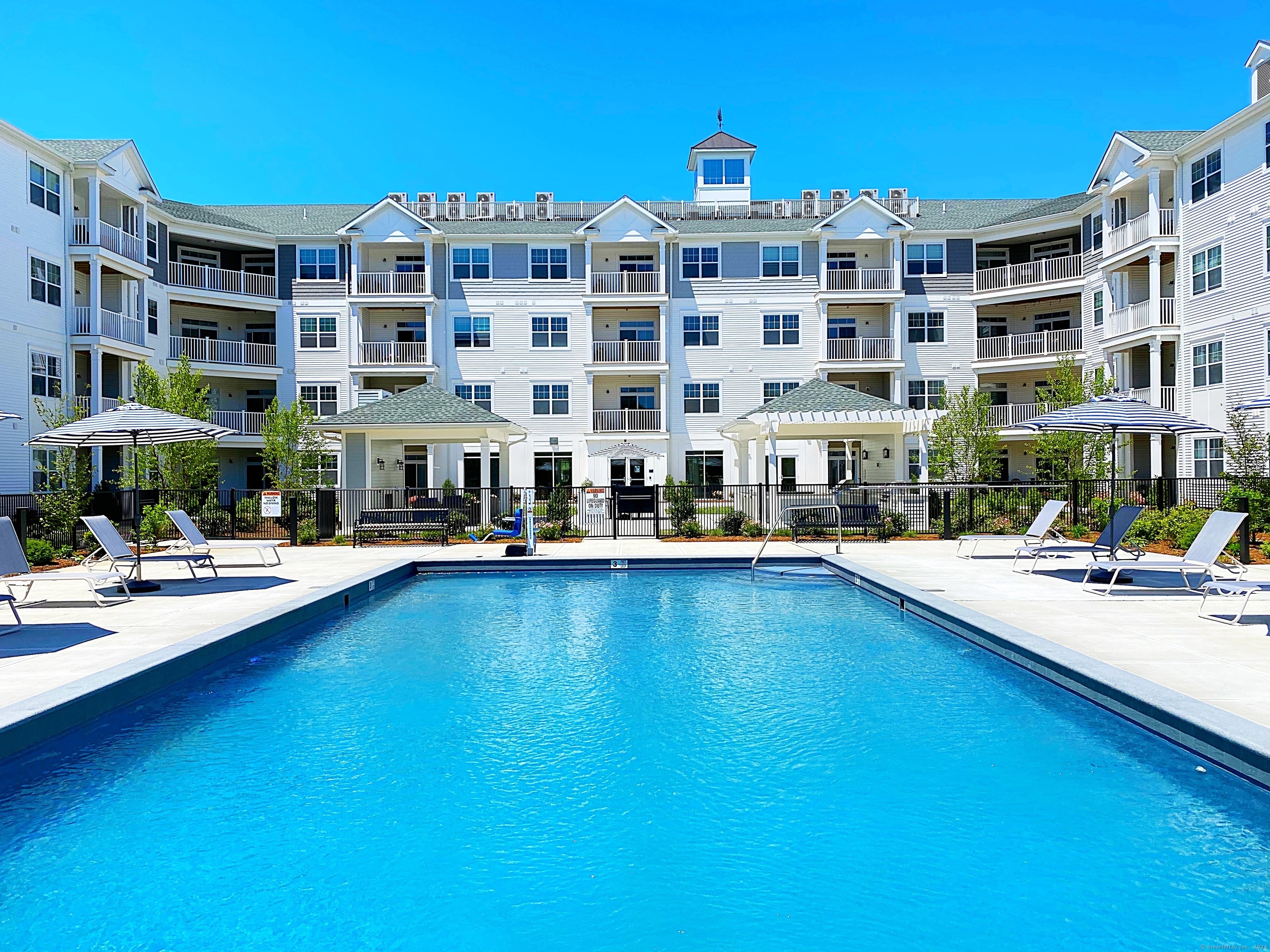 a view of building with swimming pool and sitting area