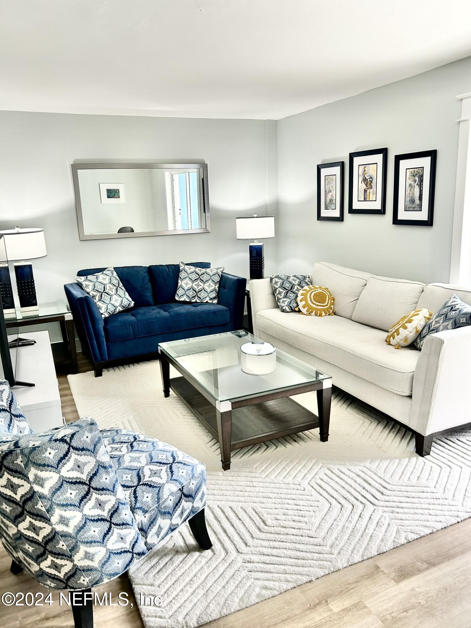 a living room with furniture and painting on the wall