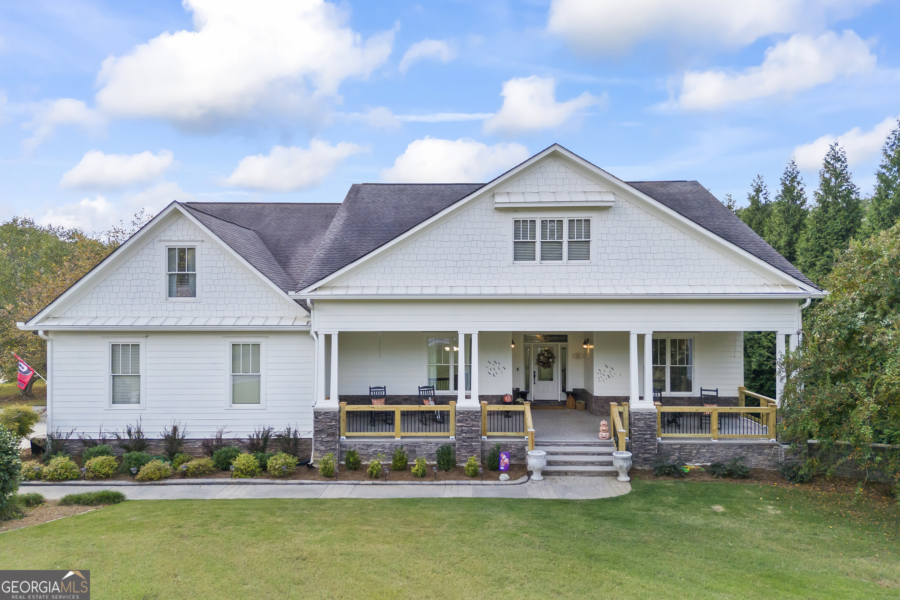 a front view of house with yard and green space