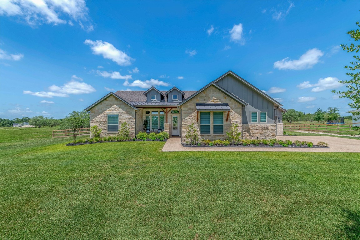 a front view of house with yard and green space