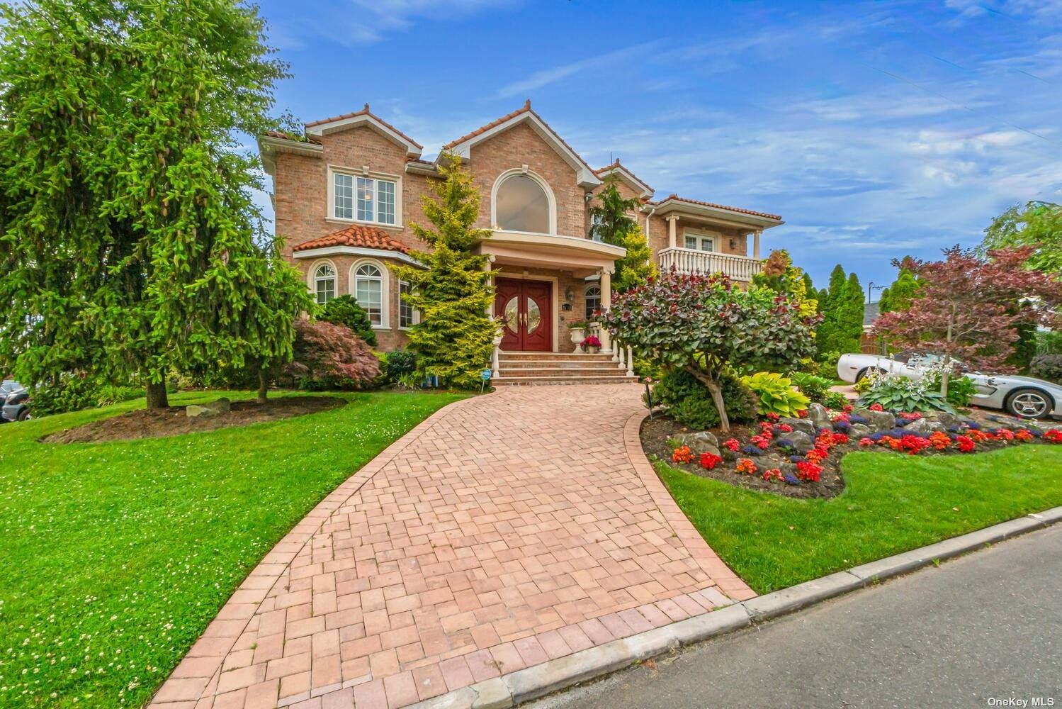 a front view of a house with a garden