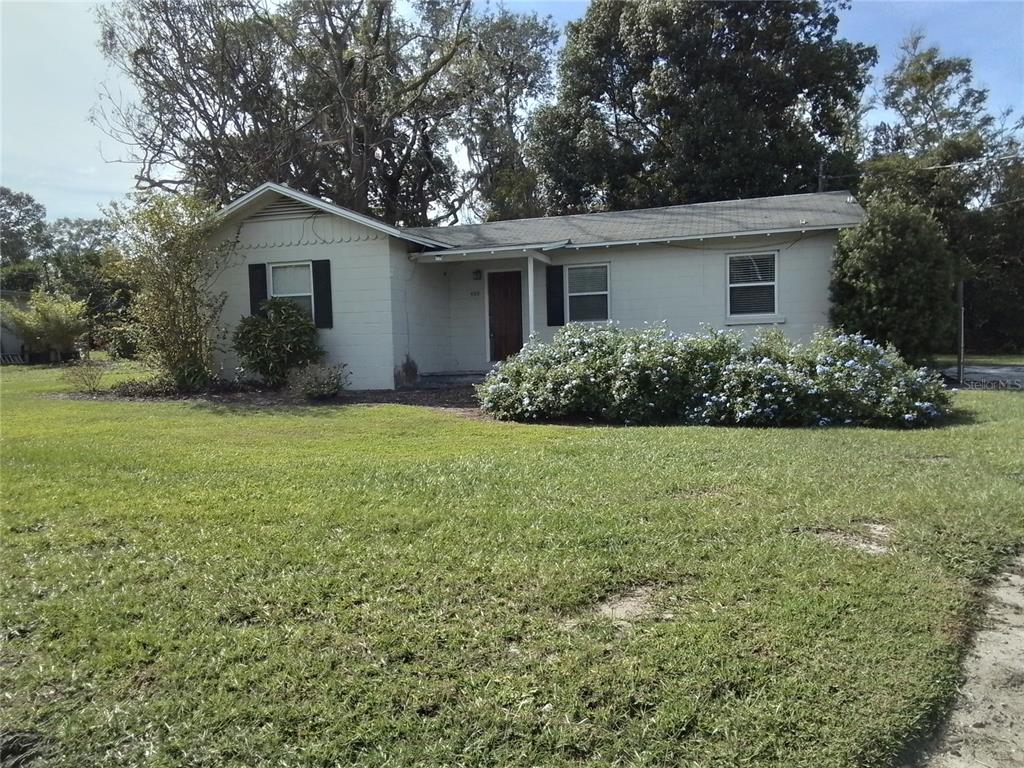 a view of a house with yard and a garden