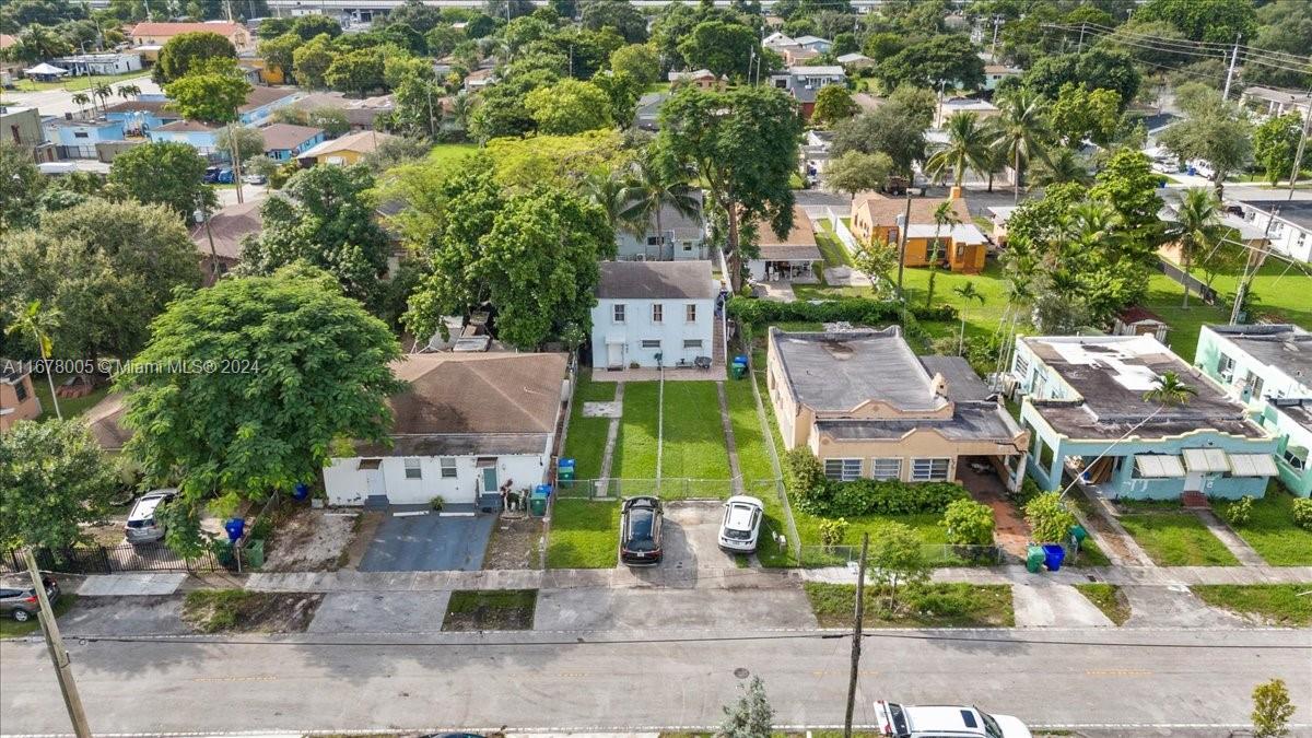 an aerial view of multiple houses with a yard