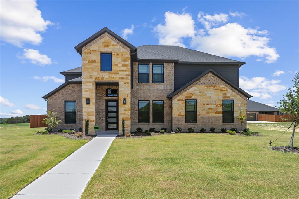 a front view of house with yard and green space