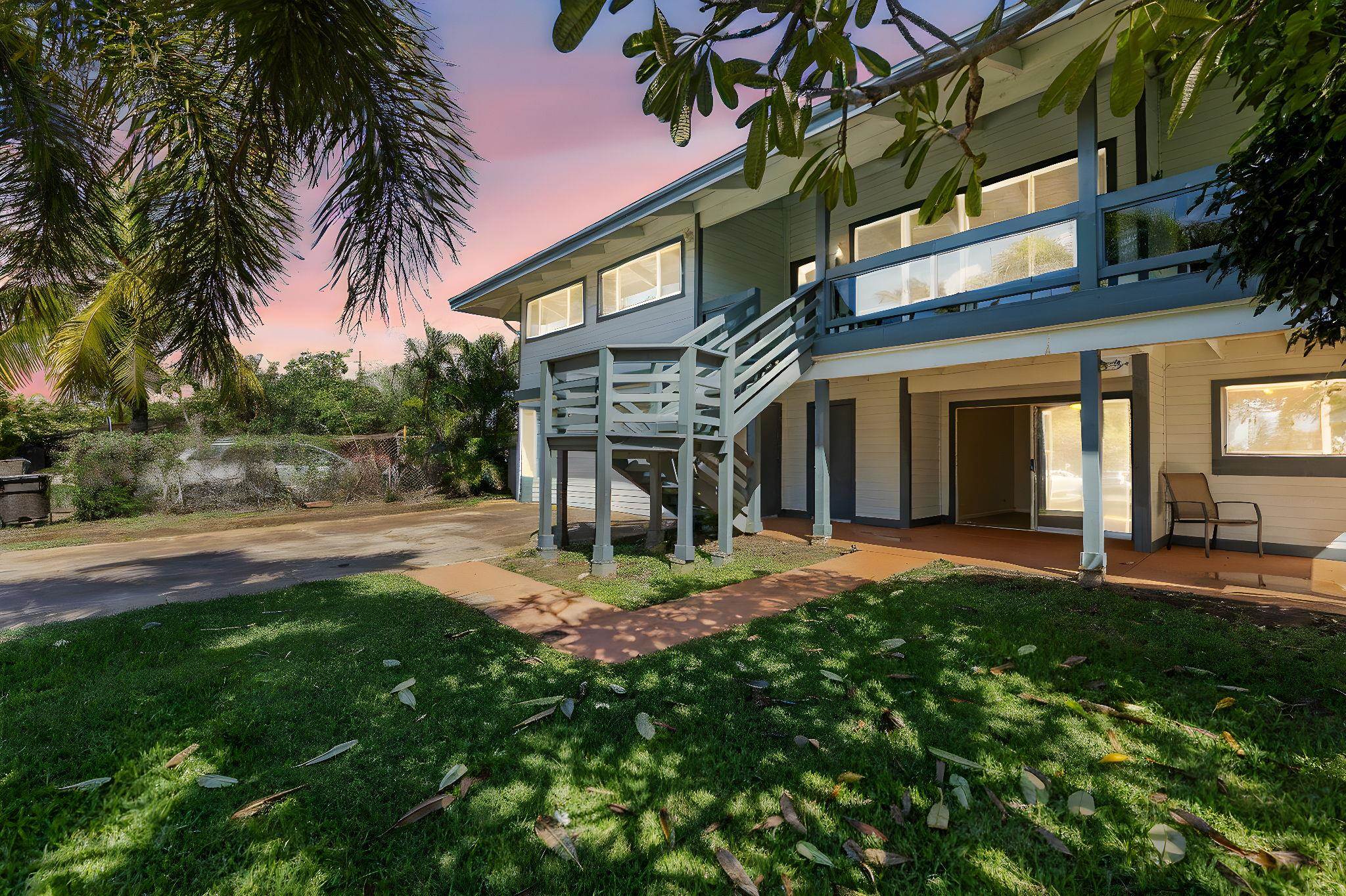 a front view of house with yard and outdoor seating