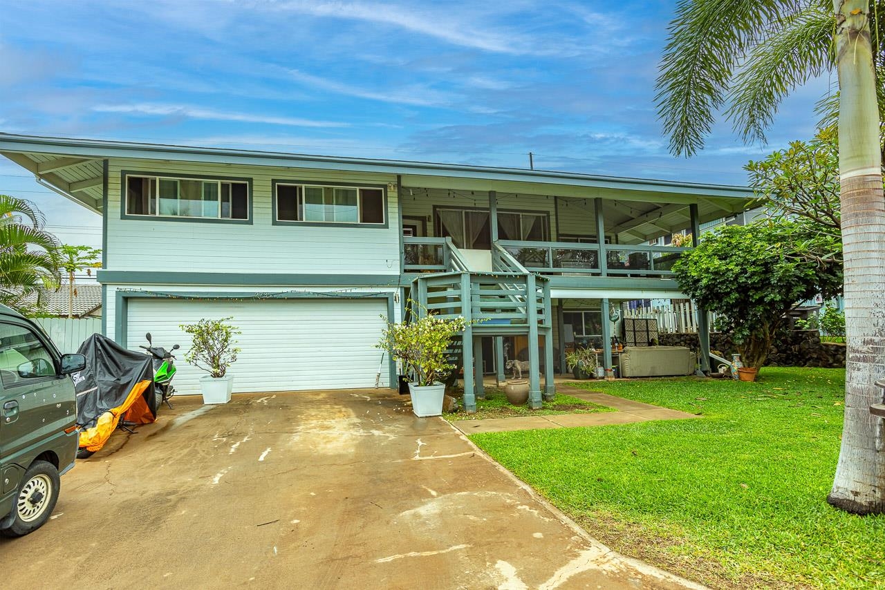 a view of a house with a patio and a yard