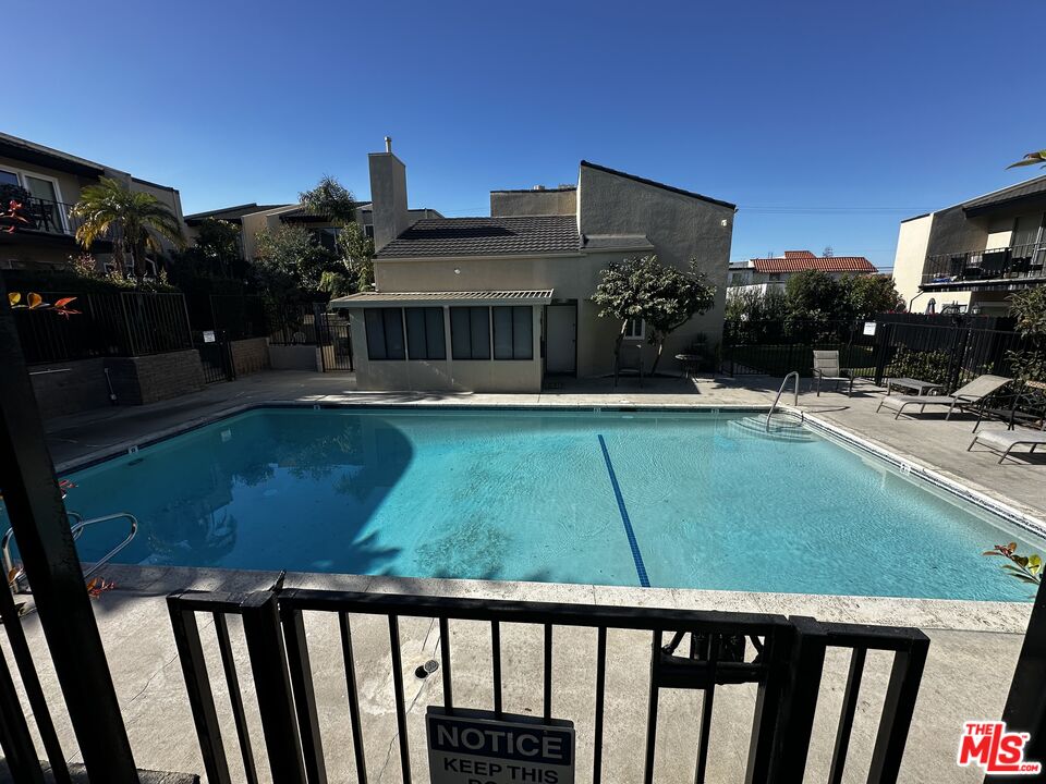 a view of a house with a backyard porch and sitting area